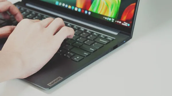 Person typing on a laptop keyboard