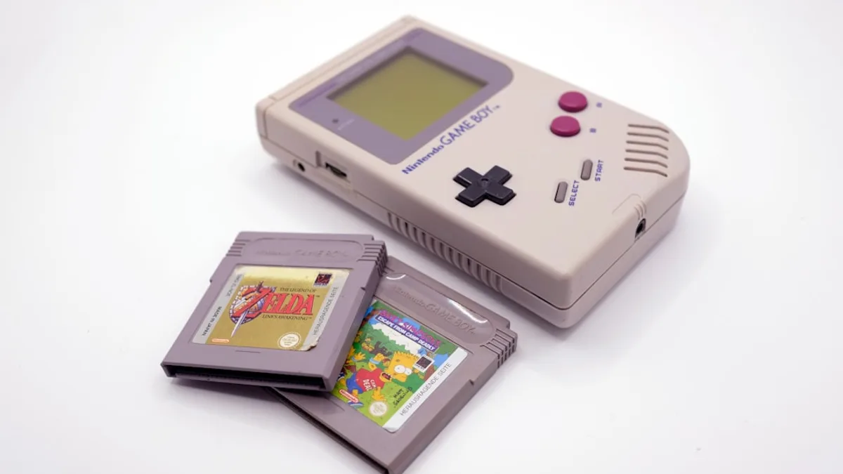 a nintendo game boy with a card and a case
