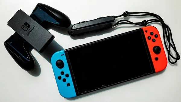 white nintendo switch beside black usb flash drive