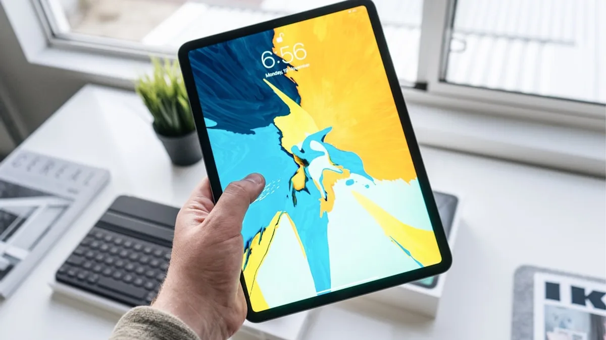 person holding turned-on black iPad