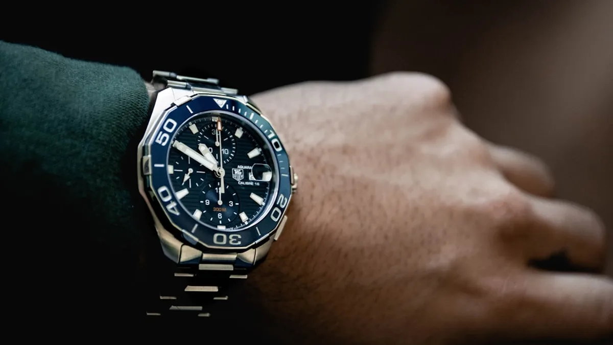 round black chronograph watch at 5:50