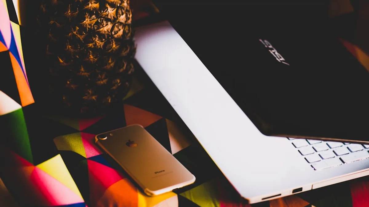 gold iPhone 7 beside Asus laptop