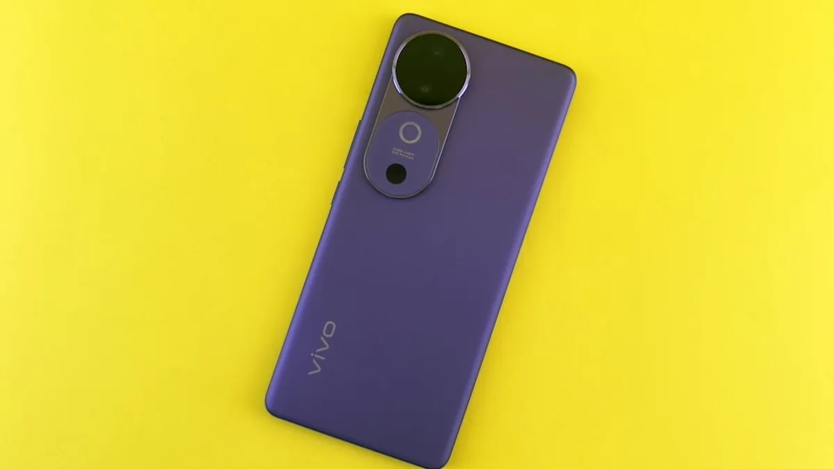 Purple smartphone with camera lens on a yellow background.
