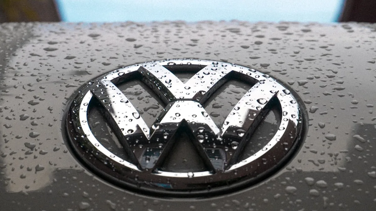 water dew on silver Volkswagen car emblem