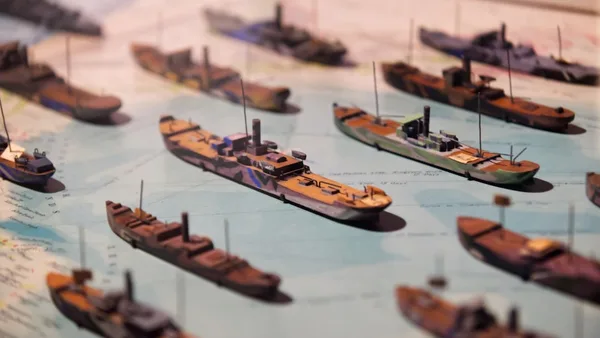 Miniature ships are displayed on a map.