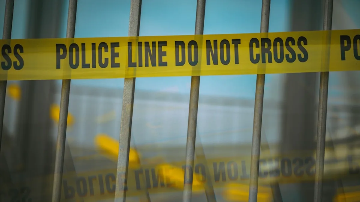 a close up of a yellow police line behind bars
