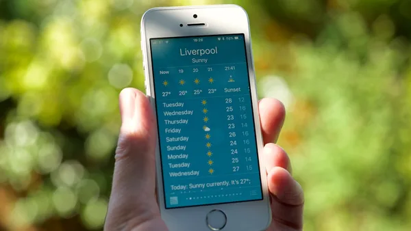 person holding turned on silver iPhone 5s displaying liverpool