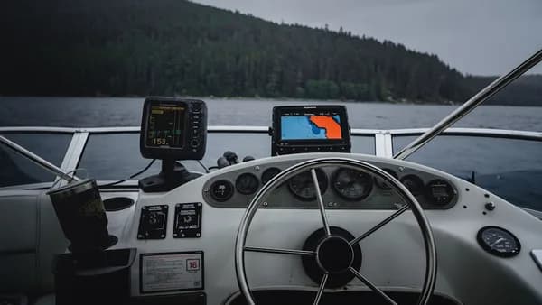 two black fish finders on a fishing boat