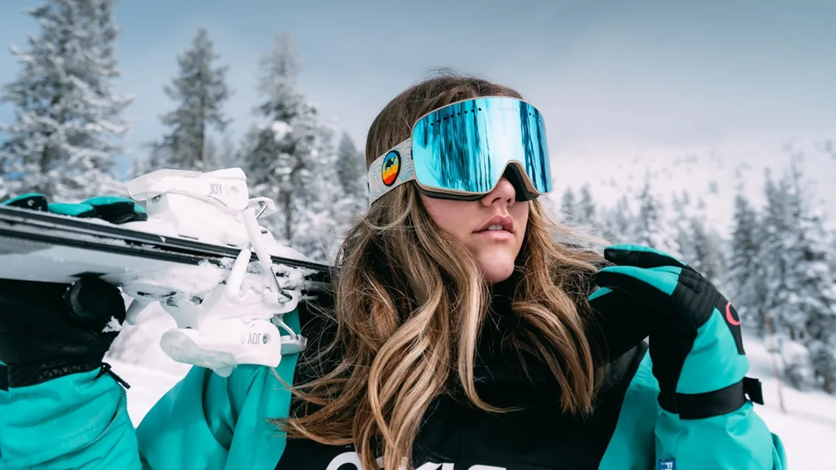 woman in black and white adidas jacket wearing blue sunglasses