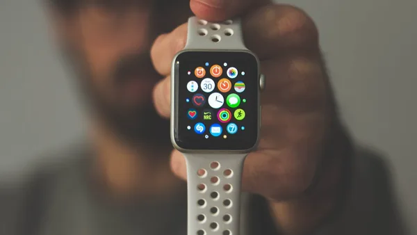 person holding silver aluminum case Apple Watch