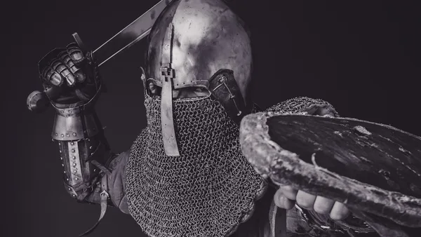 man with steel and chainmail armor holding sword