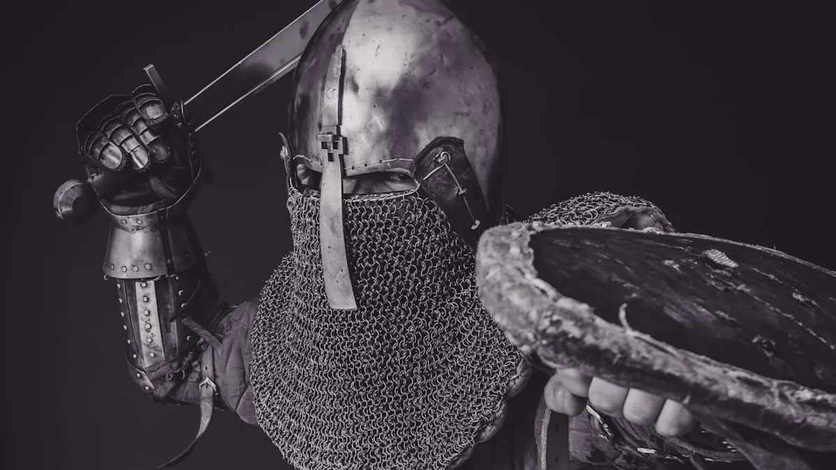 man with steel and chainmail armor holding sword